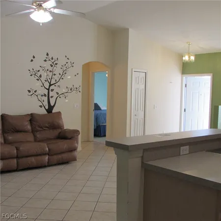 a living room with furniture and a chandelier