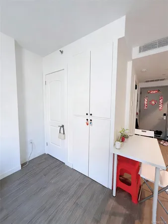 a view of a room with gym equipment and lots of potted plants