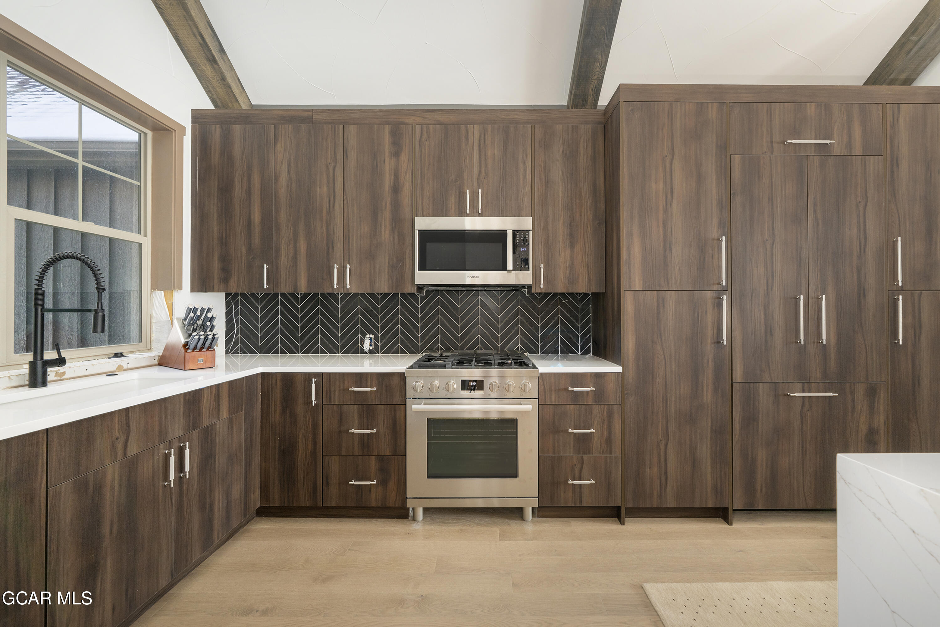 178 Eagle Ridge Drive Granby, CO 80446 - Photo 15 of 45 a kitchen with stainless steel appliances a stove a sink and a microwave