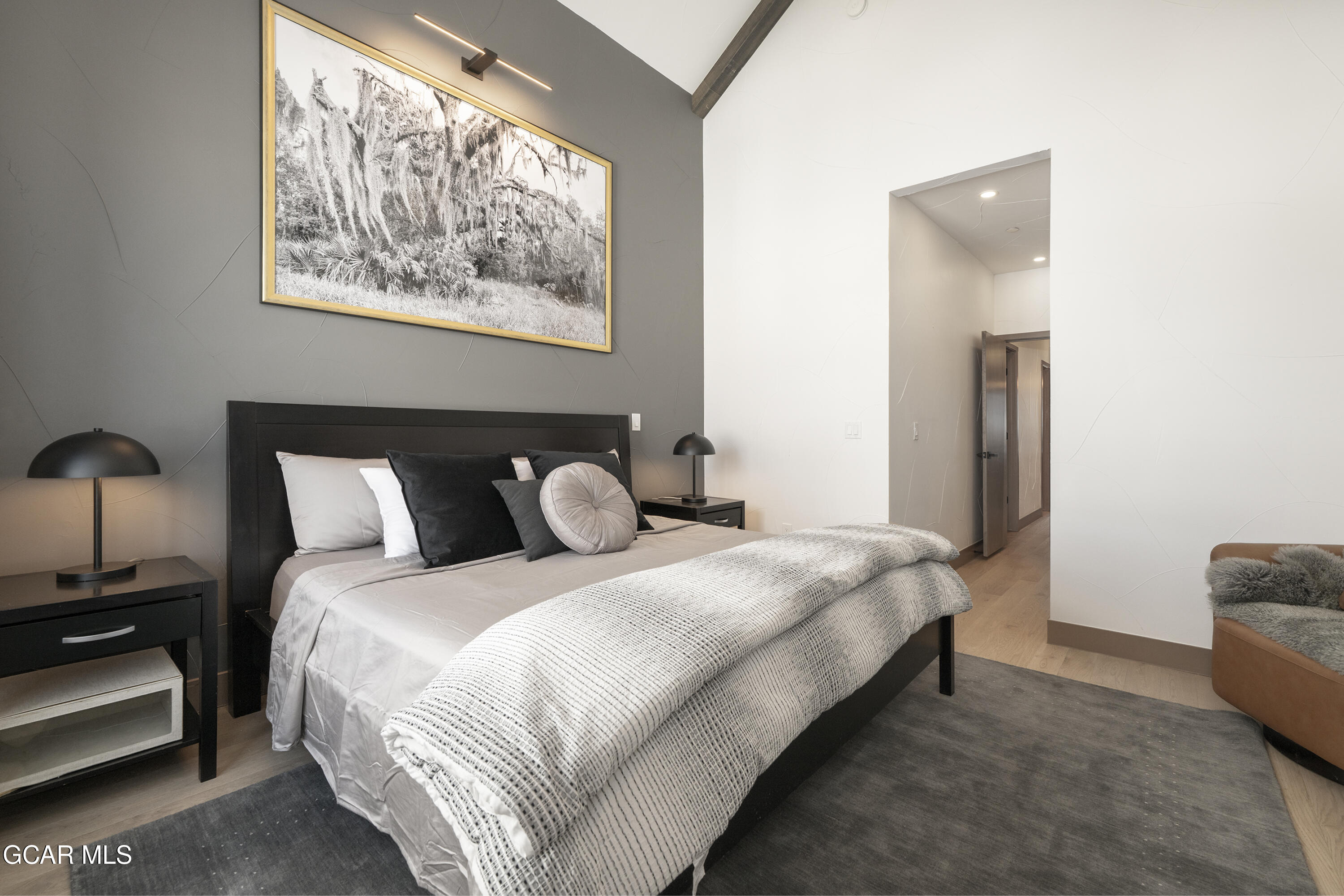 178 Eagle Ridge Drive Granby, CO 80446 - Photo 20 of 45 a bedroom with bed a lamp and a large window