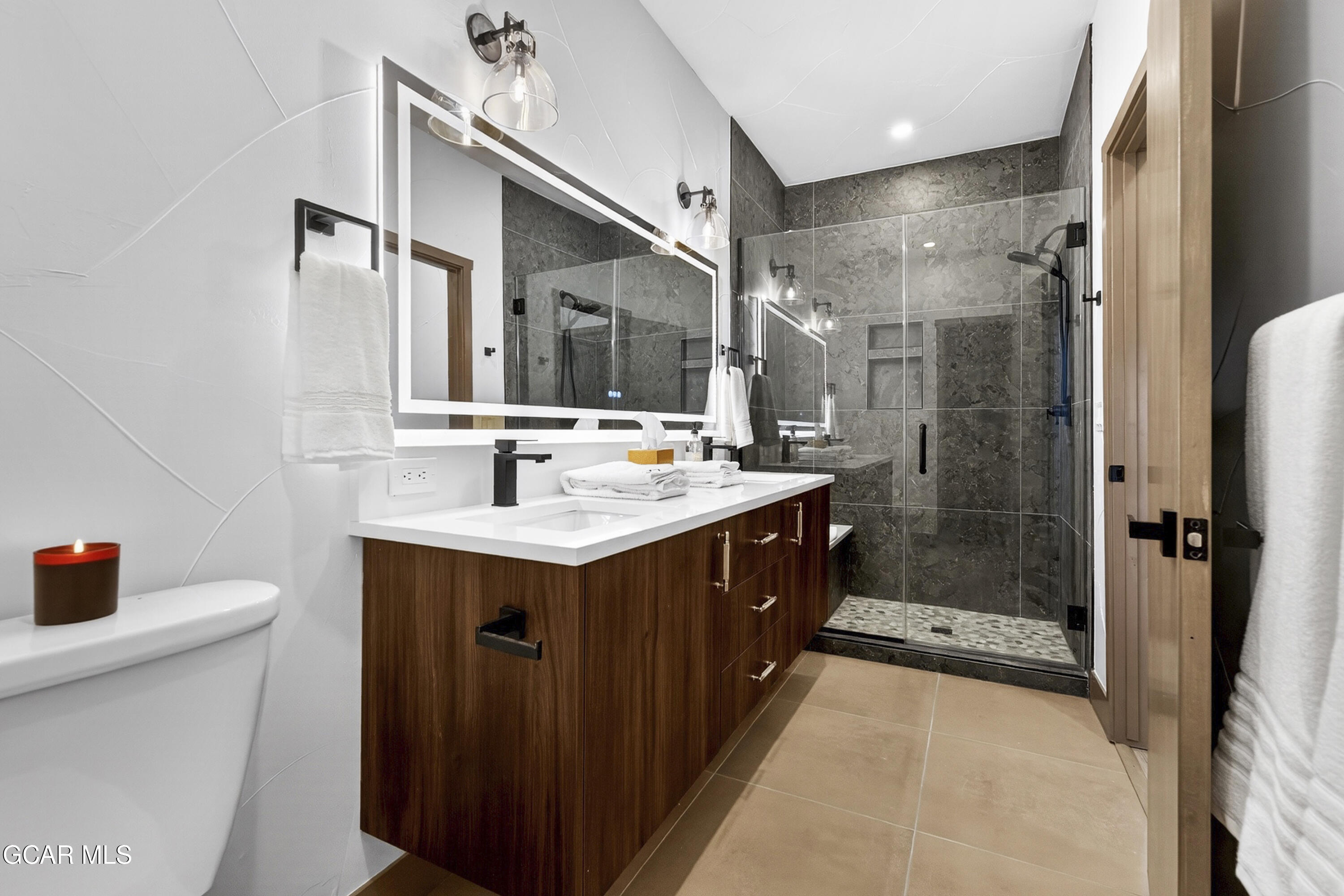 178 Eagle Ridge Drive Granby, CO 80446 - Photo 22 of 45 a bathroom with a sink mirror and shower