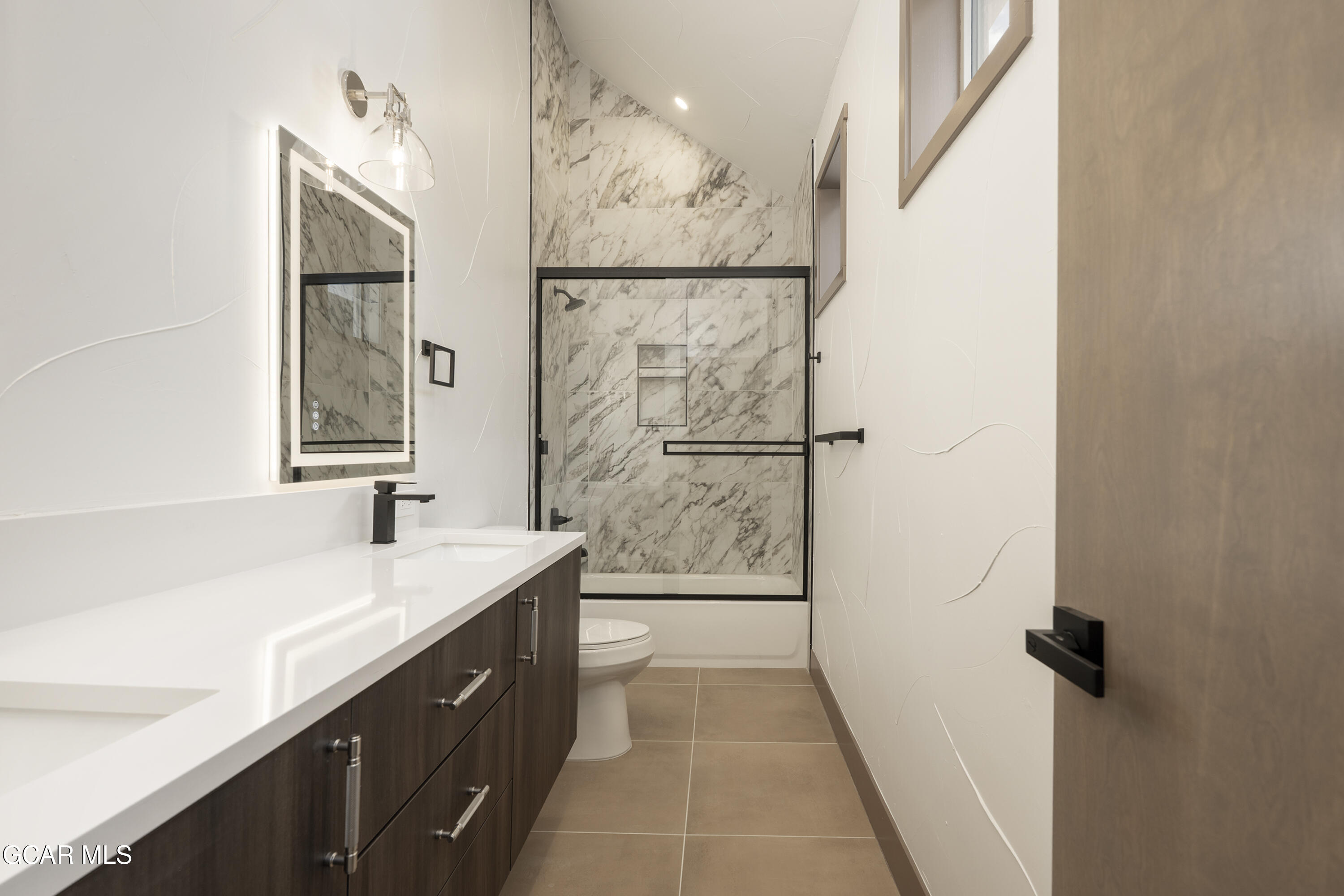 178 Eagle Ridge Drive Granby, CO 80446 - Photo 25 of 45 a bathroom with a sink a mirror and a shower