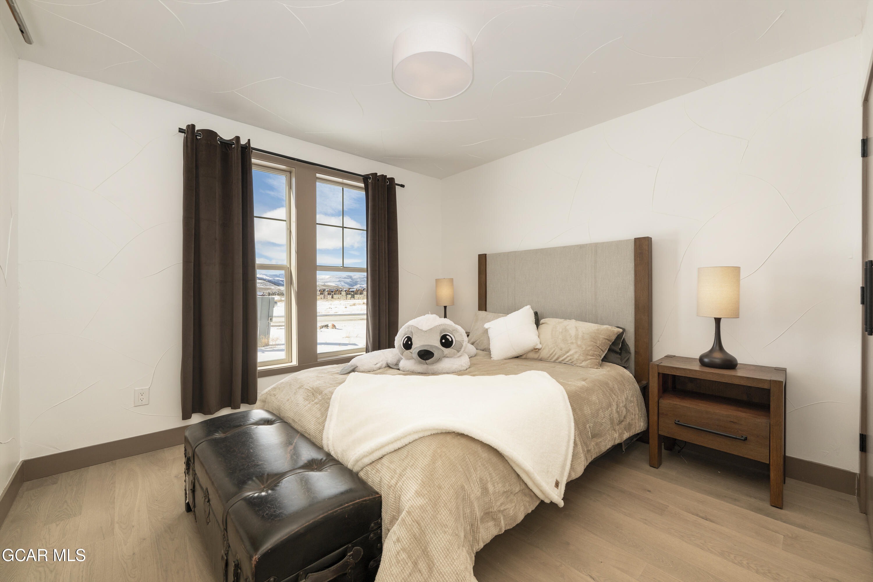 178 Eagle Ridge Drive Granby, CO 80446 - Photo 31 of 45 a bedroom with a bed and a large window