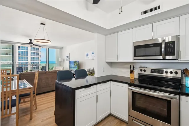 a kitchen with a stove a sink and a microwave