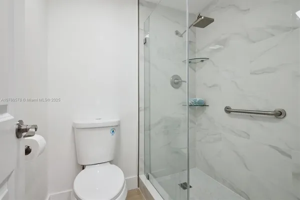 a bathroom with a toilet and a shower