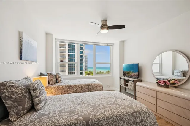 a bedroom with a large bed and a window