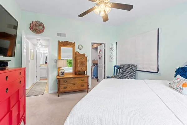 a bathroom with a granite countertop sink a toilet and shower
