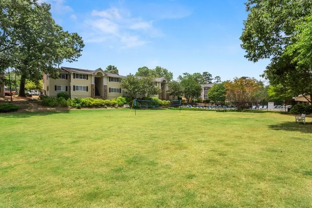a view of yard with swimming pool and green space