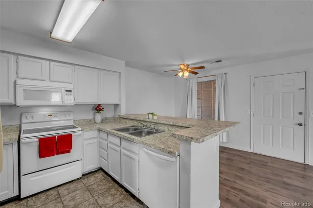 a kitchen with stainless steel appliances granite countertop a stove sink and cabinets