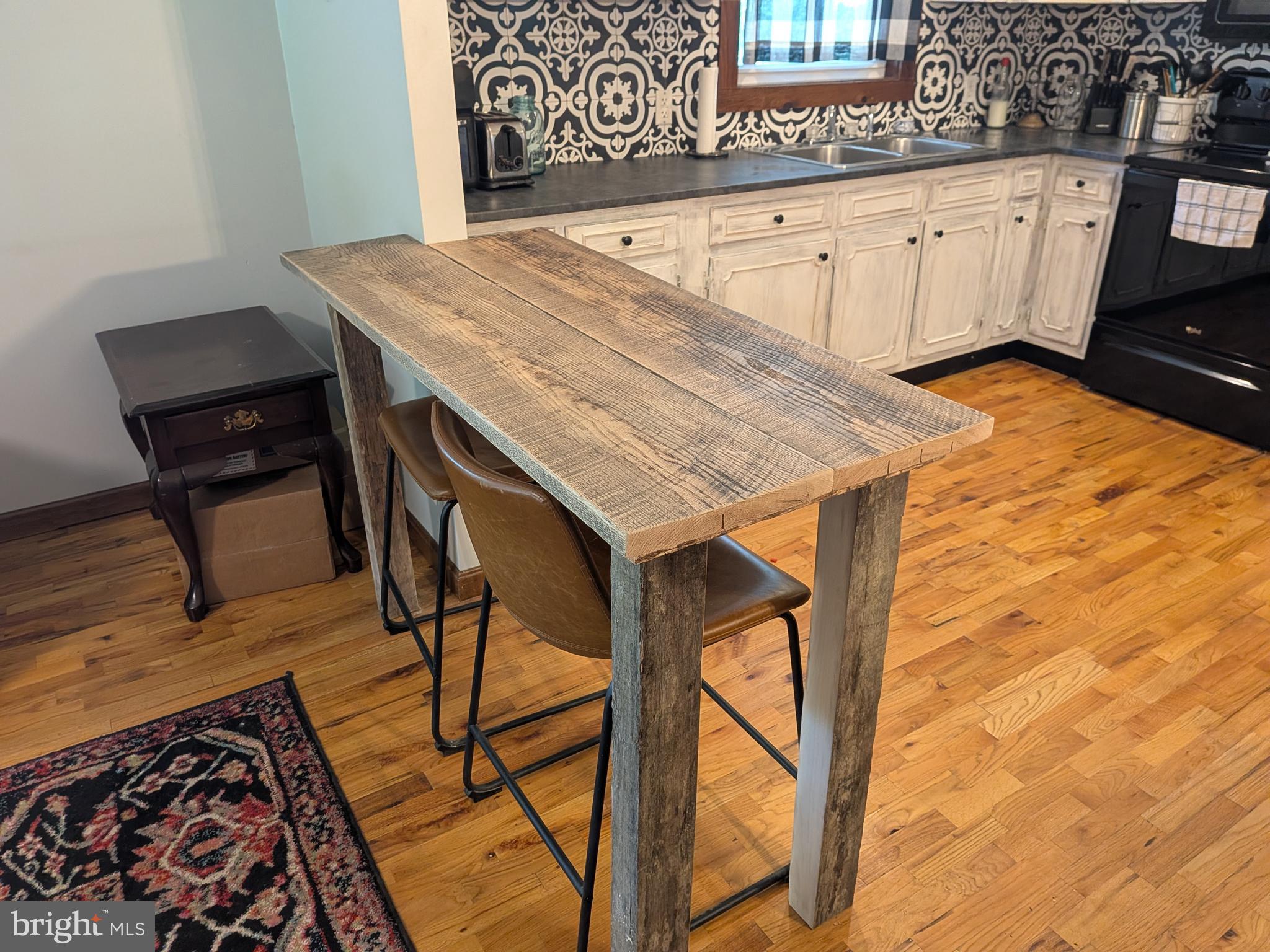 2418 Muddy Run Road Mifflintown, PA 17059 - Photo 22 of 44 a view of a kitchen area with furniture and wooden floor