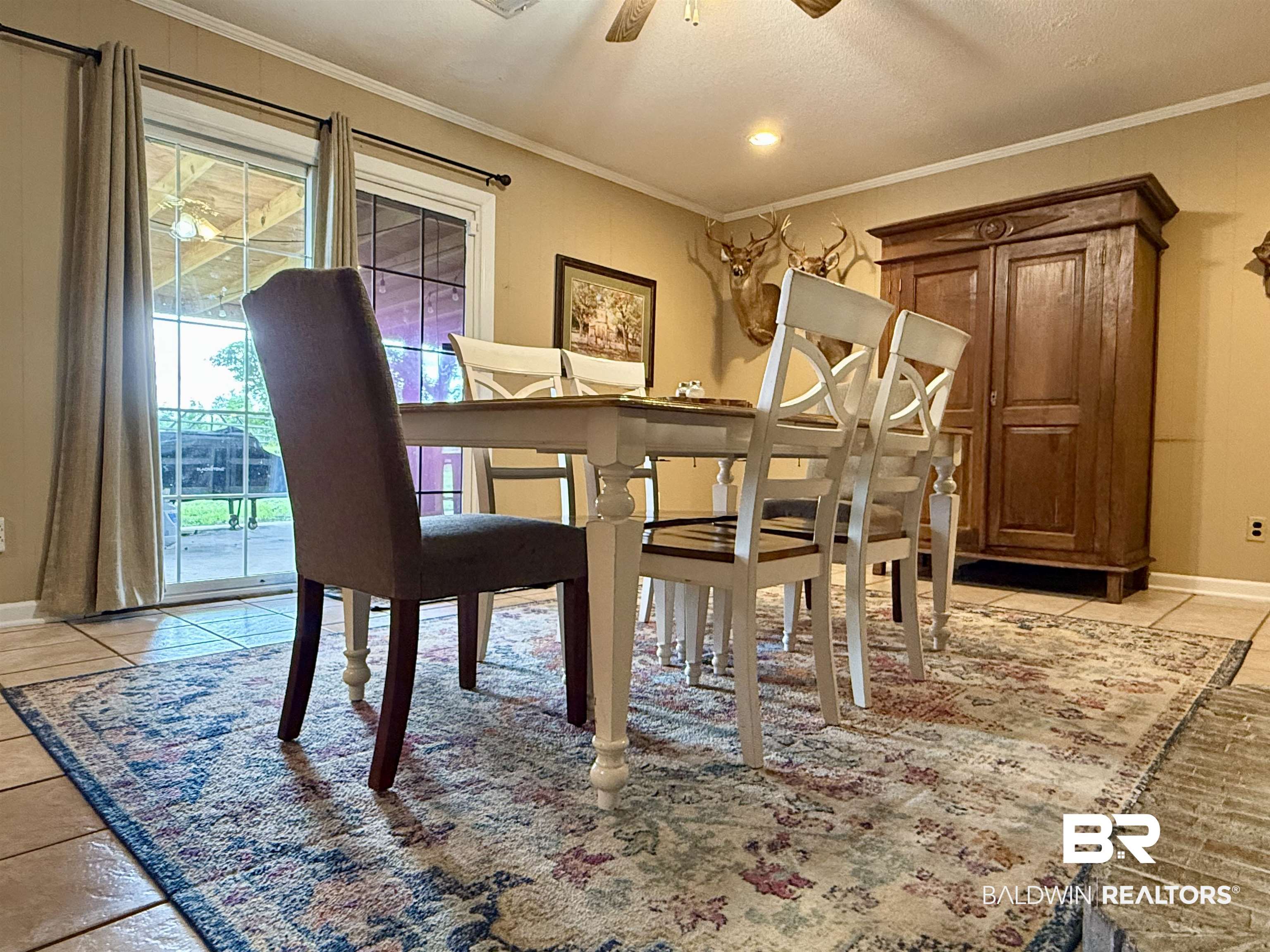 5971 Appleton Road Brewton, AL 36426 - Photo 7 of 23 Dining area with light tile patterned flooring, ceiling fan, and ornamental molding