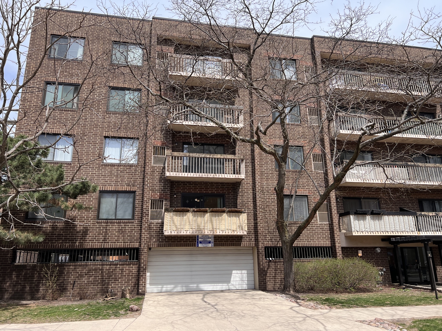 6102 North Sheridan Road, Unit 201 Chicago, IL 60660 - Photo 1 of 15 a front view of a building with large trees