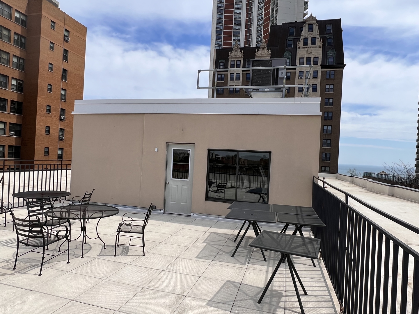 6102 North Sheridan Road, Unit 201 Chicago, IL 60660 - Photo 14 of 15 a patio with table and chairs and potted plants