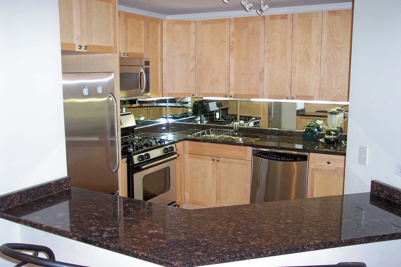 6102 North Sheridan Road, Unit 201 Chicago, IL 60660 - Photo 2 of 15 a kitchen with stainless steel appliances granite countertop a sink stove and refrigerator
