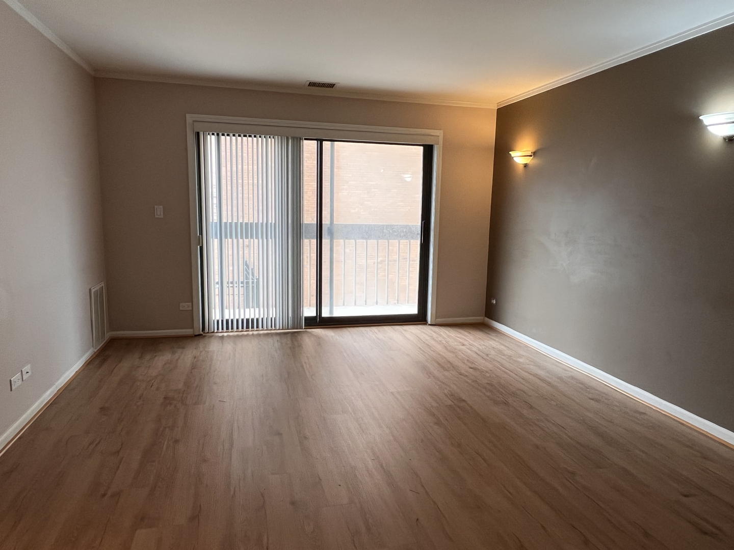 6102 North Sheridan Road, Unit 201 Chicago, IL 60660 - Photo 5 of 15 a view of an empty room with wooden floor and a window