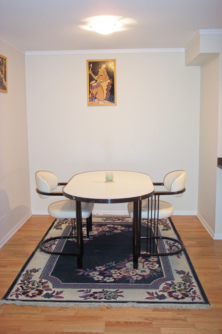 6102 North Sheridan Road, Unit 201 Chicago, IL 60660 - Photo 6 of 15 a view of a dining room with furniture