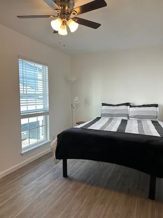 a bedroom with a bed and window