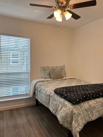 a bedroom with a bed and a window