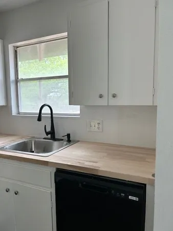 a kitchen with a sink and cabinets