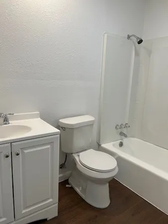 a white toilet sitting next to a bathroom sink