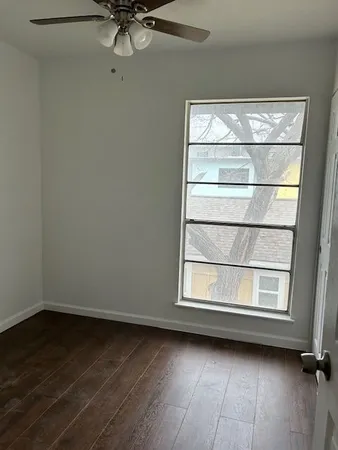 a view of a room with rack on the wall and a window