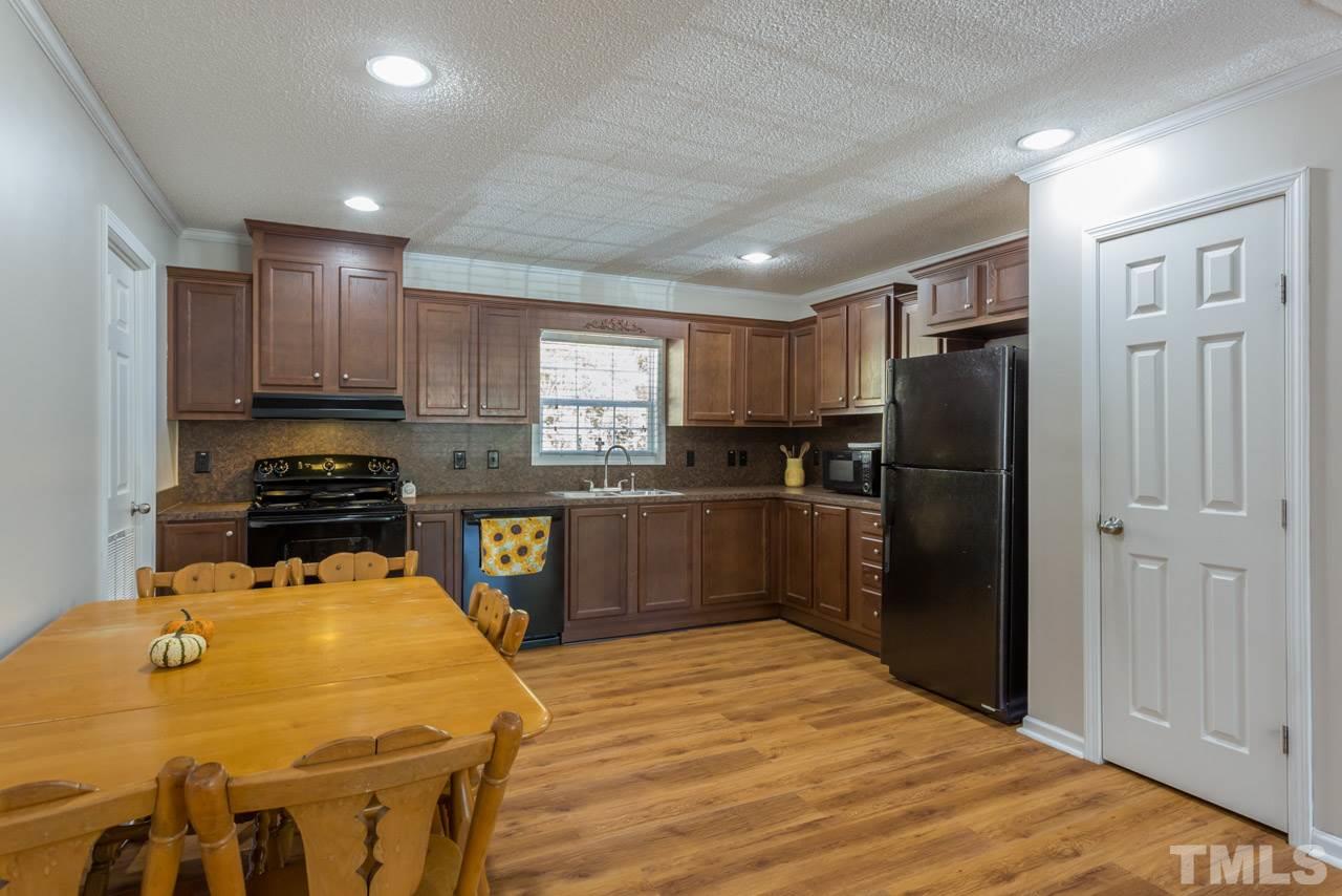 1001 Altice Drive Raleigh, NC 27603 - Photo 13 of 24 a kitchen with a refrigerator and a stove top oven