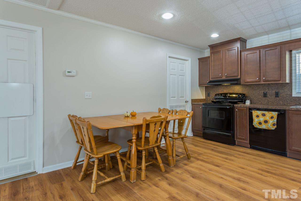 1001 Altice Drive Raleigh, NC 27603 - Photo 17 of 24 a view of a kitchen with dining table and chairs