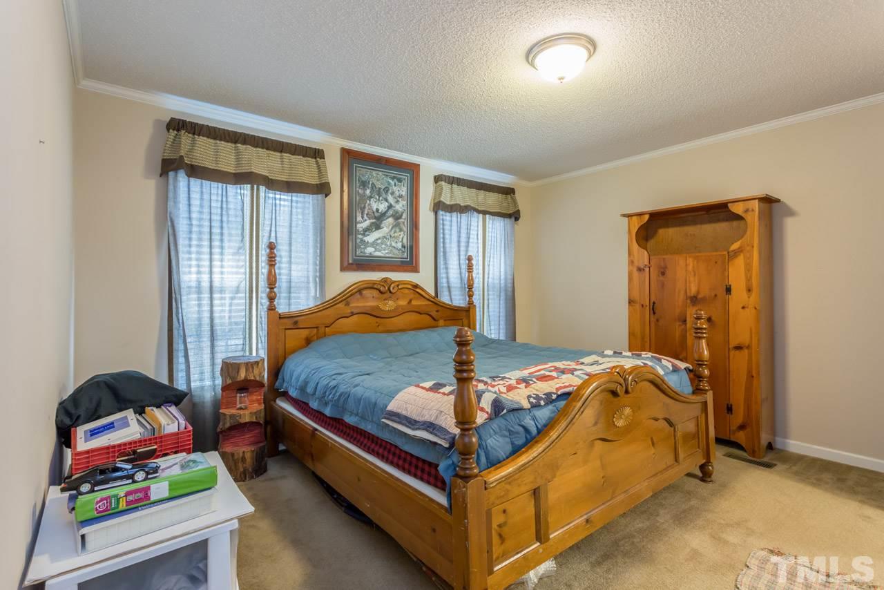 1001 Altice Drive Raleigh, NC 27603 - Photo 18 of 24 a bed sitting in a bedroom next to a window