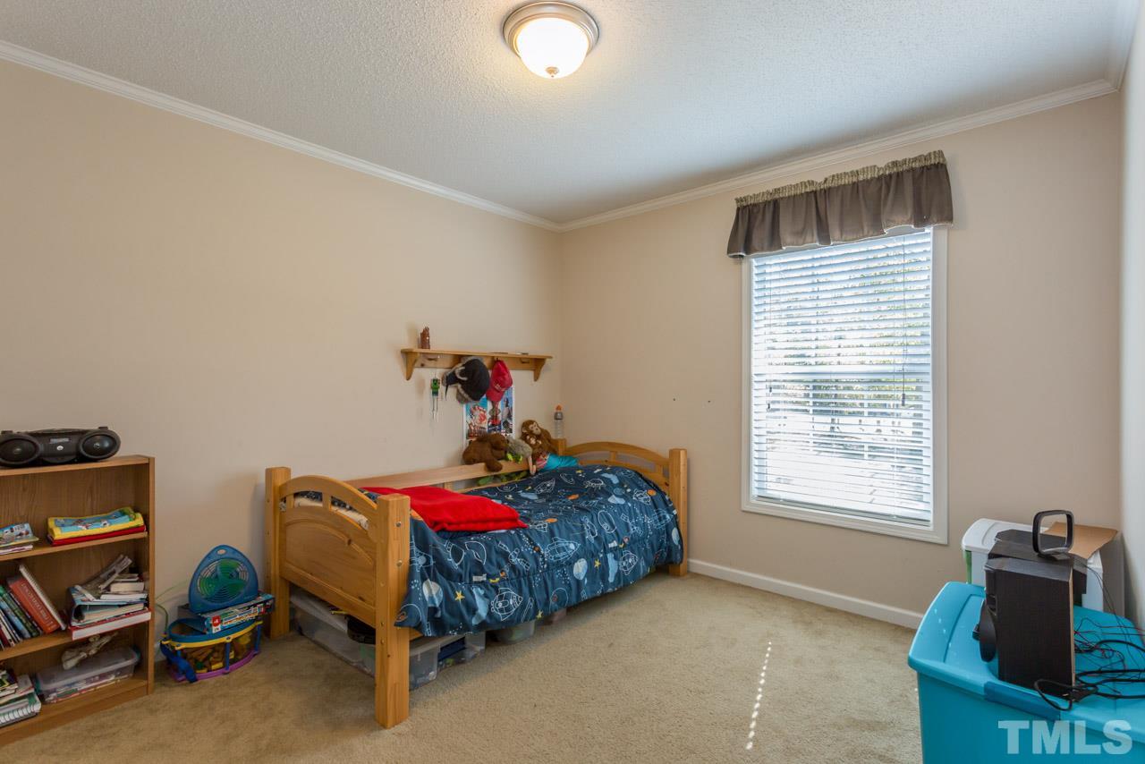 1001 Altice Drive Raleigh, NC 27603 - Photo 20 of 24 a bedroom with a bed and a window