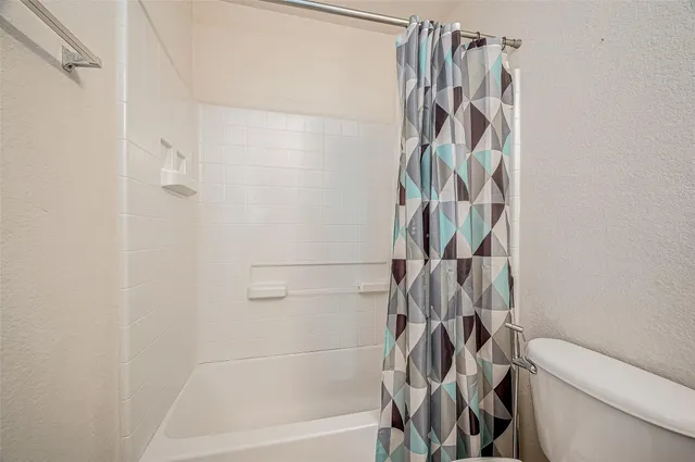 a bathroom with a shower and a toilet