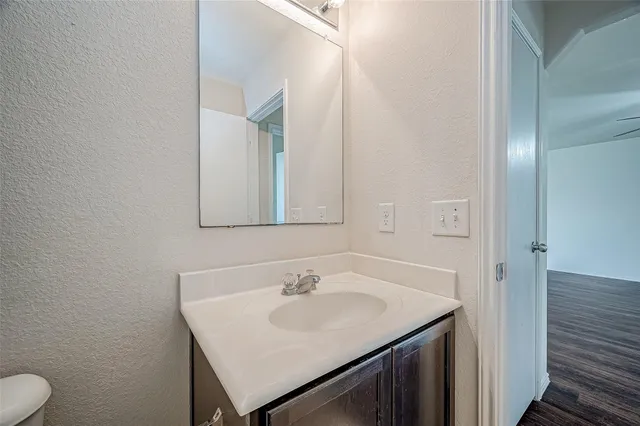 a bathroom with a sink toilet and mirror