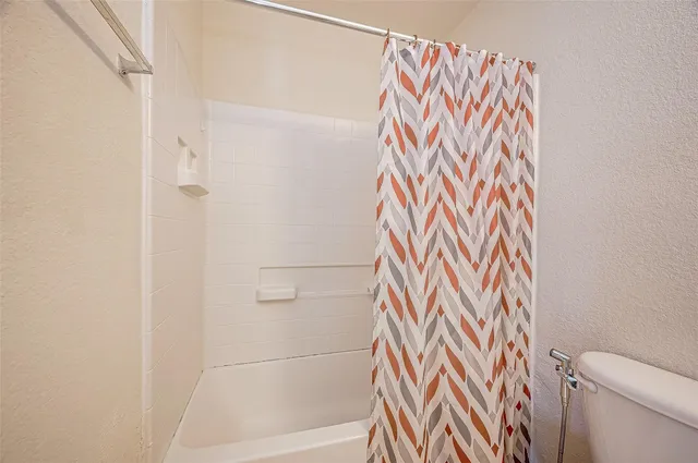 a bathroom with a shower curtain and a curtain