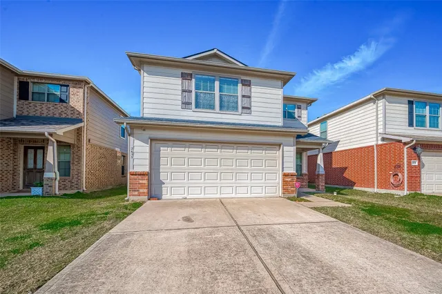 a front view of a house with a yard and garage