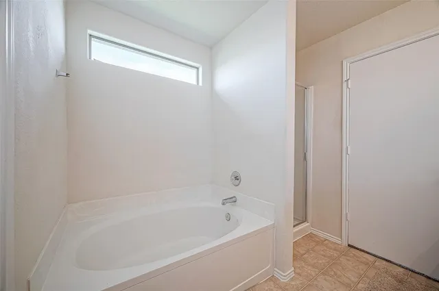 a white bath tub sitting next to a window