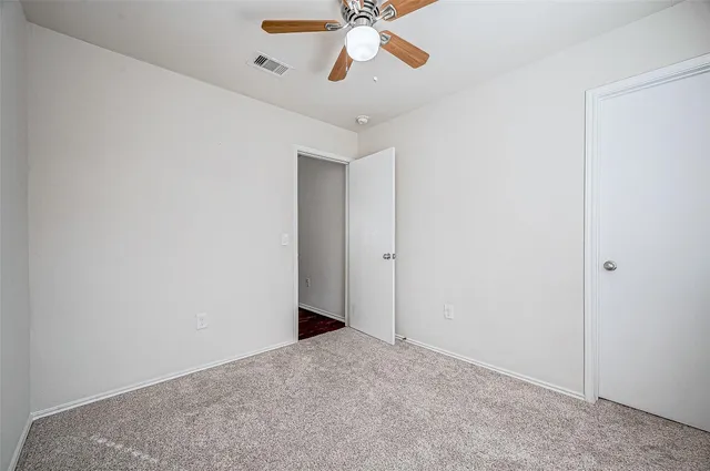 a view of a room with a ceiling fan