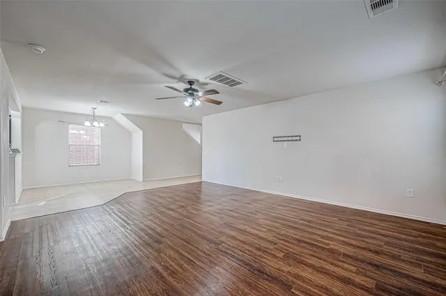 a view of an empty room and wooden floor