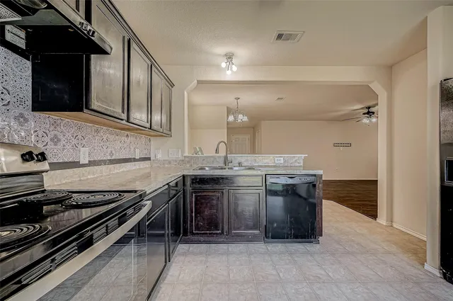 a kitchen with stainless steel appliances granite countertop a stove and a sink