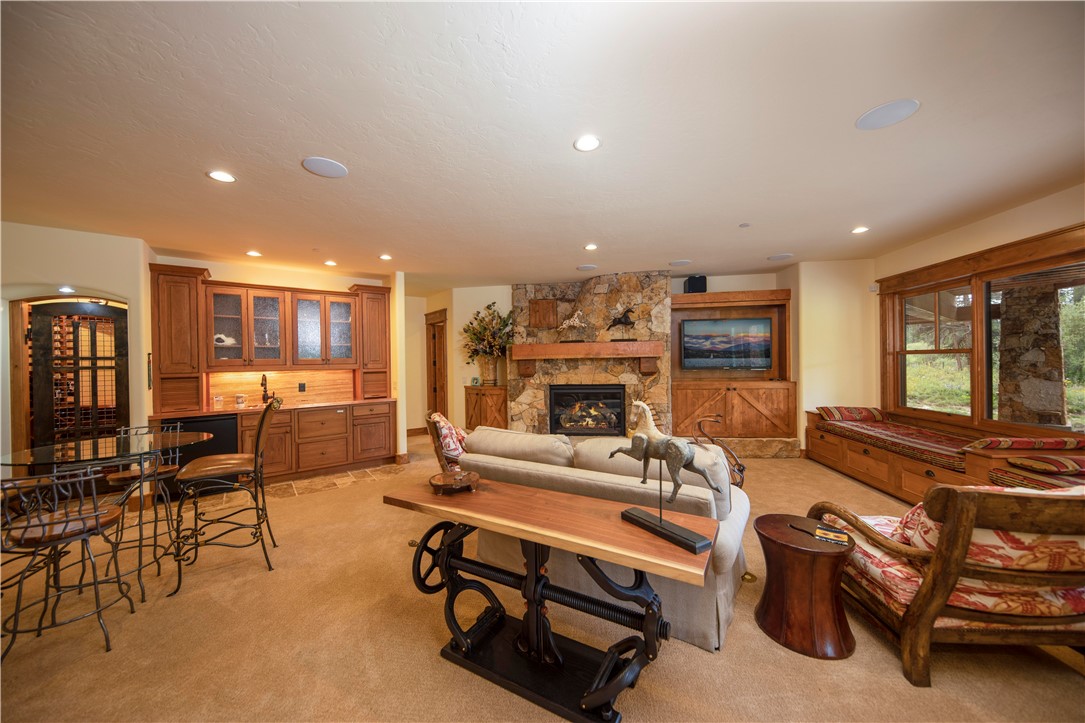 211 Highlands Drive Breckenridge, CO 80424 - Photo 18 of 35 This lower level family room has it all including a view of Breckenridge Ski Area! A copper top wet bar, wine room, game area and fireplace are just some of the amazing features.