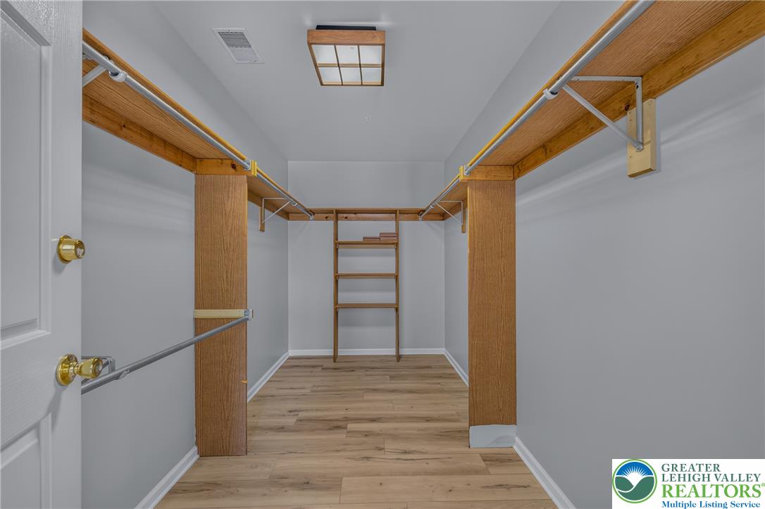 630 Clearfield Road Nazareth, PA 18064 - Photo 49 of 100 Custom wooden shelving and durable plank flooring maximize organization in this functional walk-in closet.