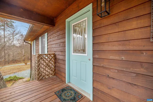 a view of a big room with wooden floor and windows