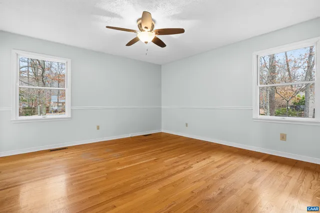 a view of a kitchen with furniture and wooden floor