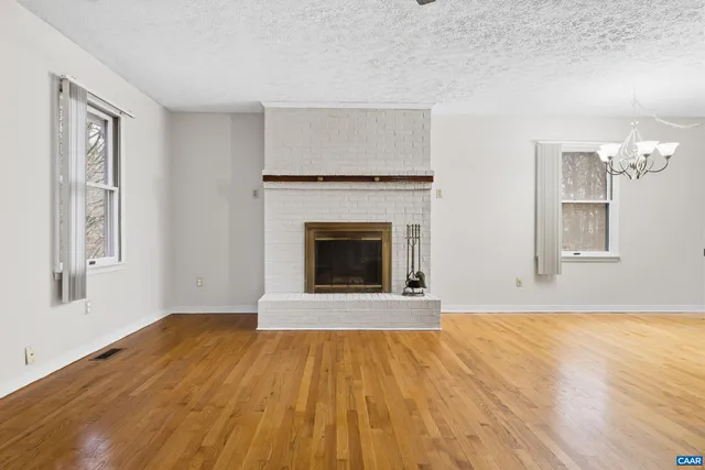 a view of a livingroom with an empty space and a ceiling fan