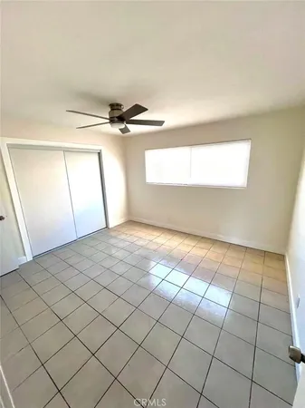 a view of a room with a window and a ceiling fan