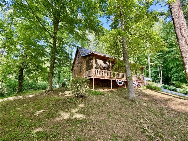 238 Trails End Road Blue Ridge, GA 30513 - Photo 4 of 32 a view of a house with a yard and large trees
