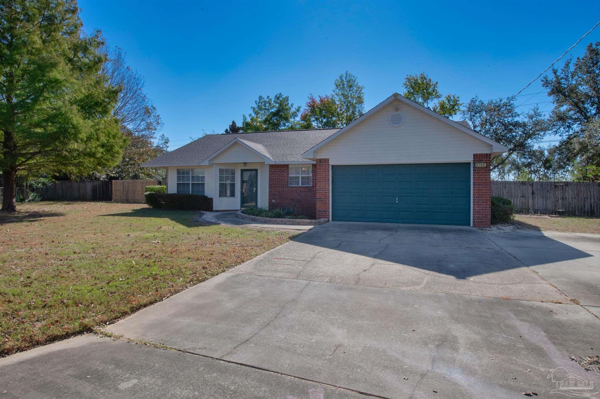 2702 Beacon Court Navarre, FL 32566 - Photo 2 of 29 a front view of a house with a yard and garage