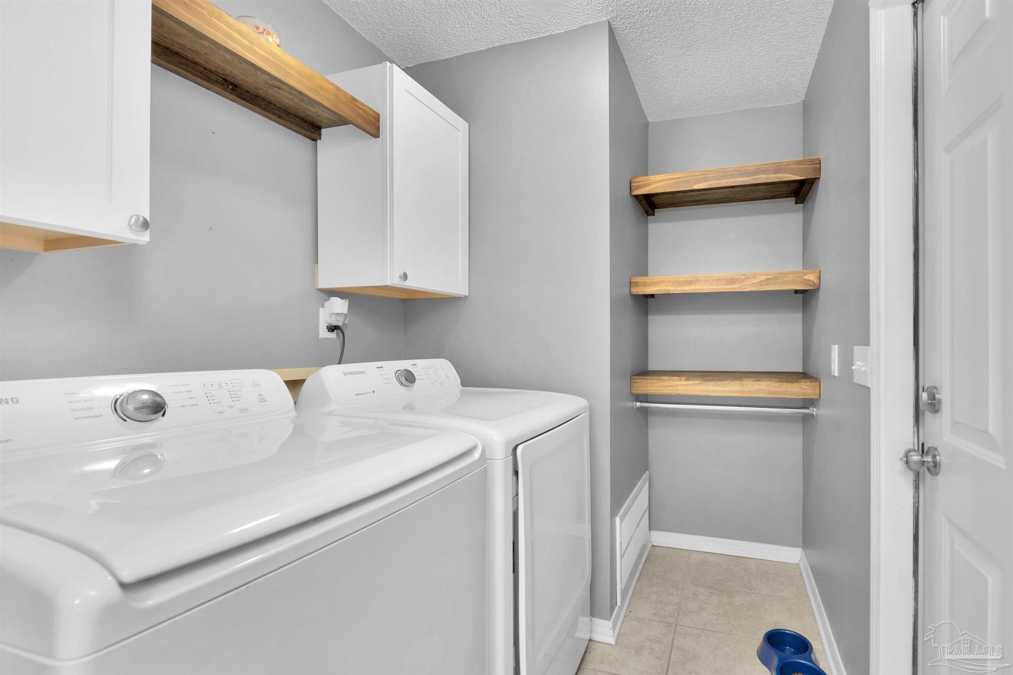 2702 Beacon Court Navarre, FL 32566 - Photo 12 of 29 a utility room with dryer and washer