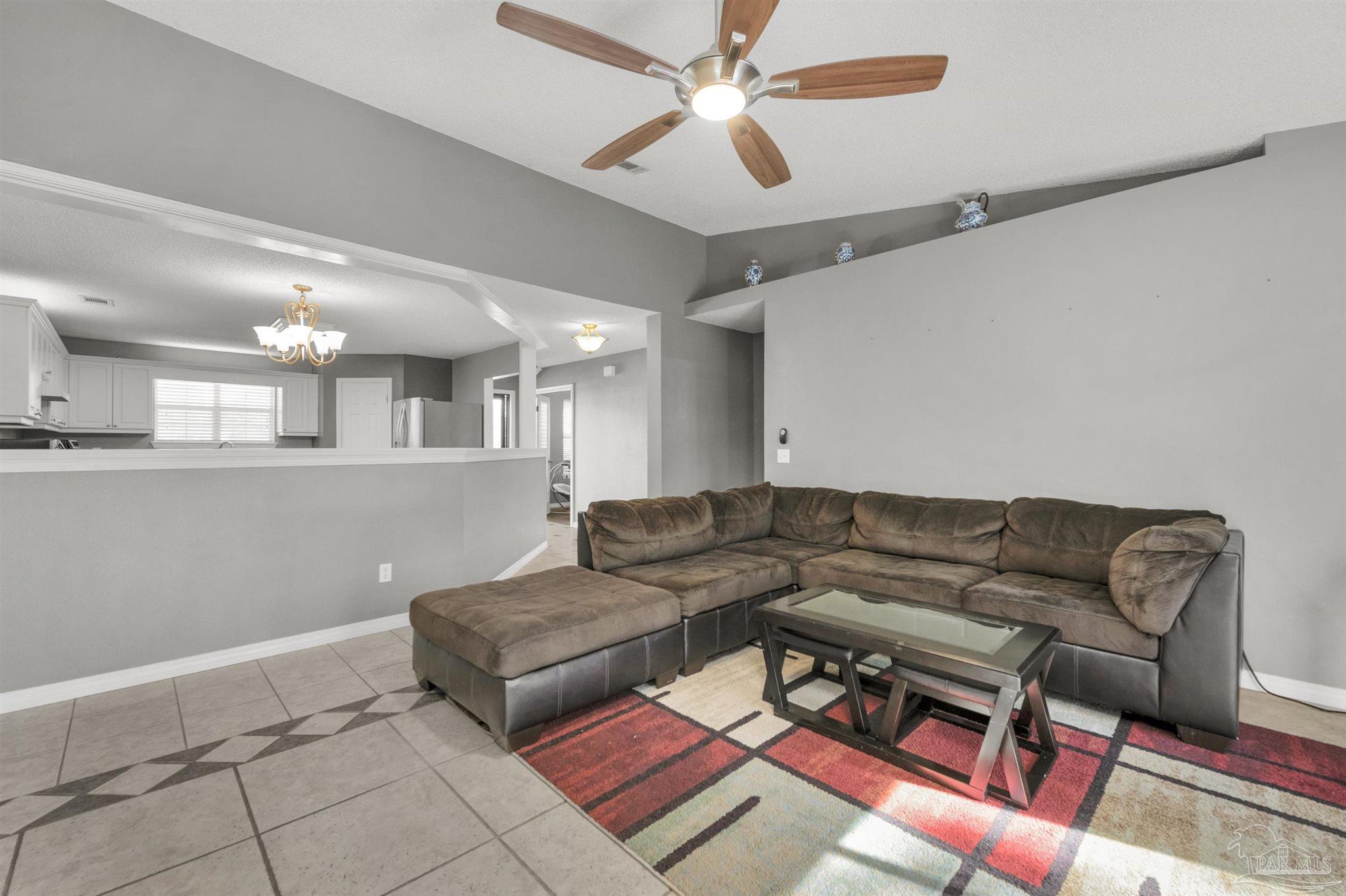 2702 Beacon Court Navarre, FL 32566 - Photo 13 of 29 a living room with furniture and a rug