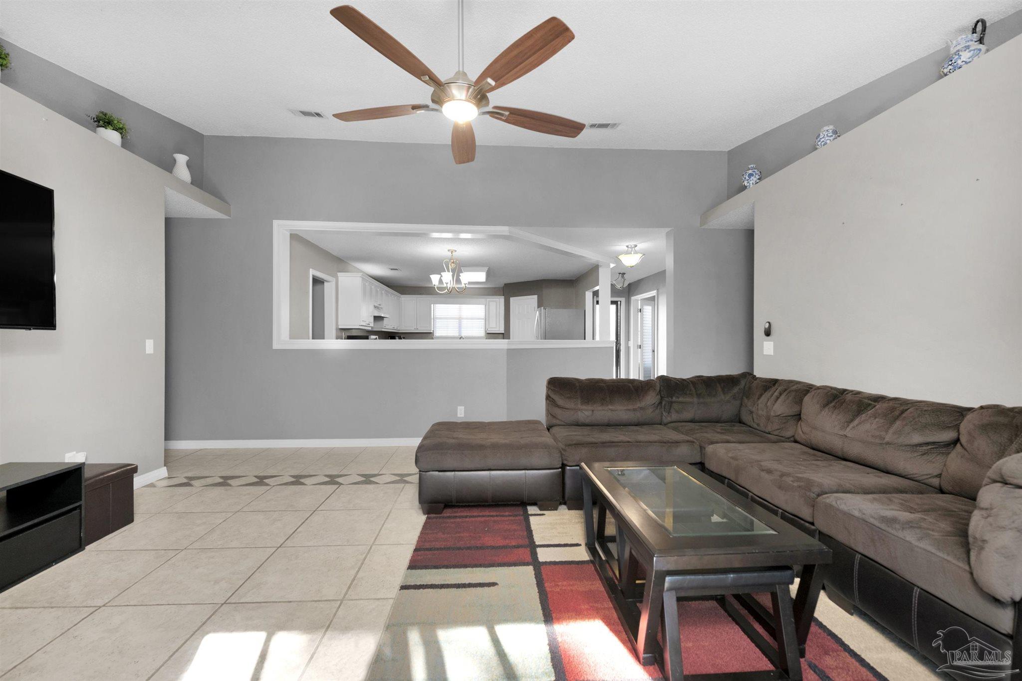 2702 Beacon Court Navarre, FL 32566 - Photo 14 of 29 a living room with furniture and a flat screen tv