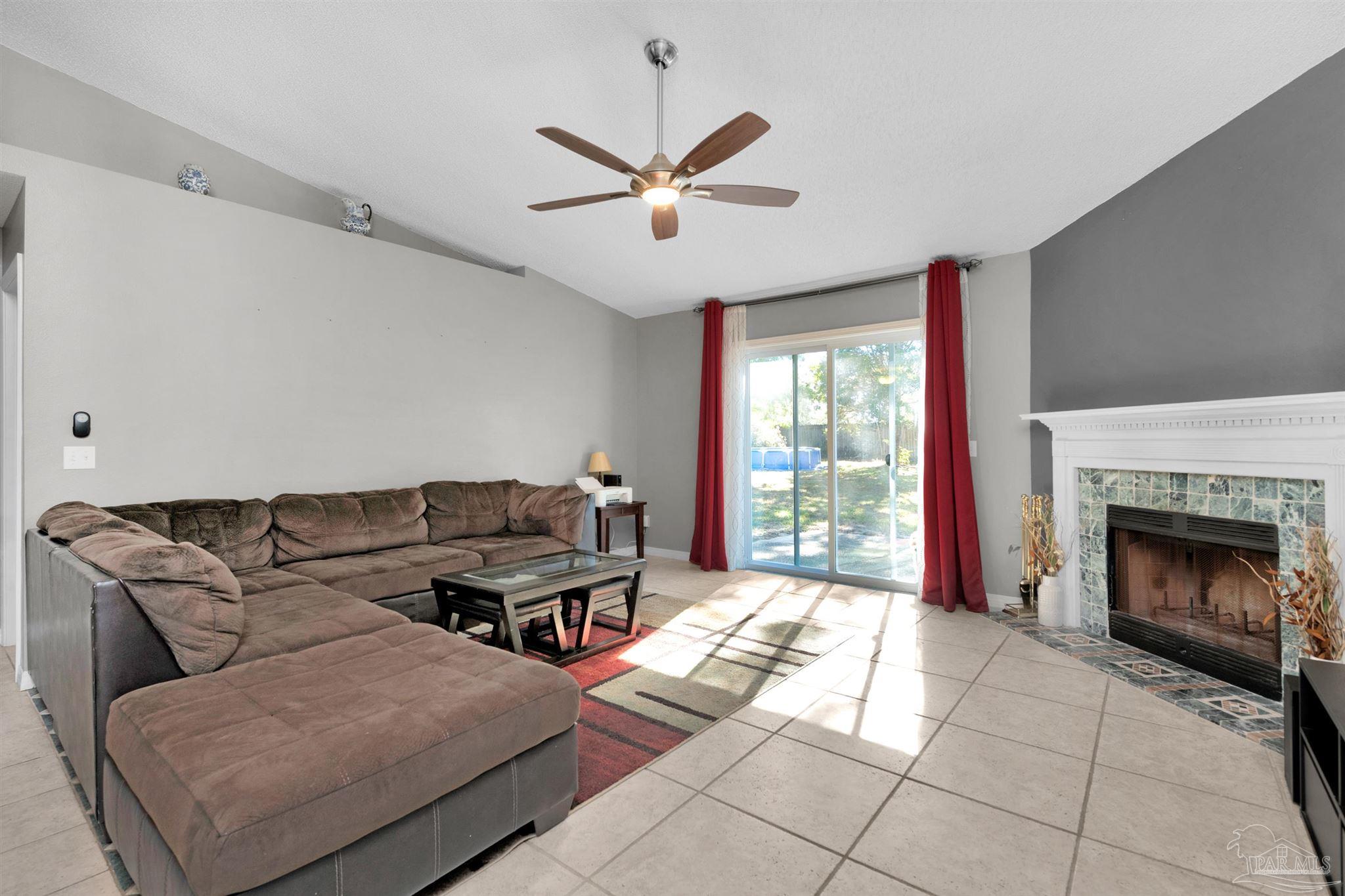 2702 Beacon Court Navarre, FL 32566 - Photo 15 of 29 a living room with furniture and a fireplace