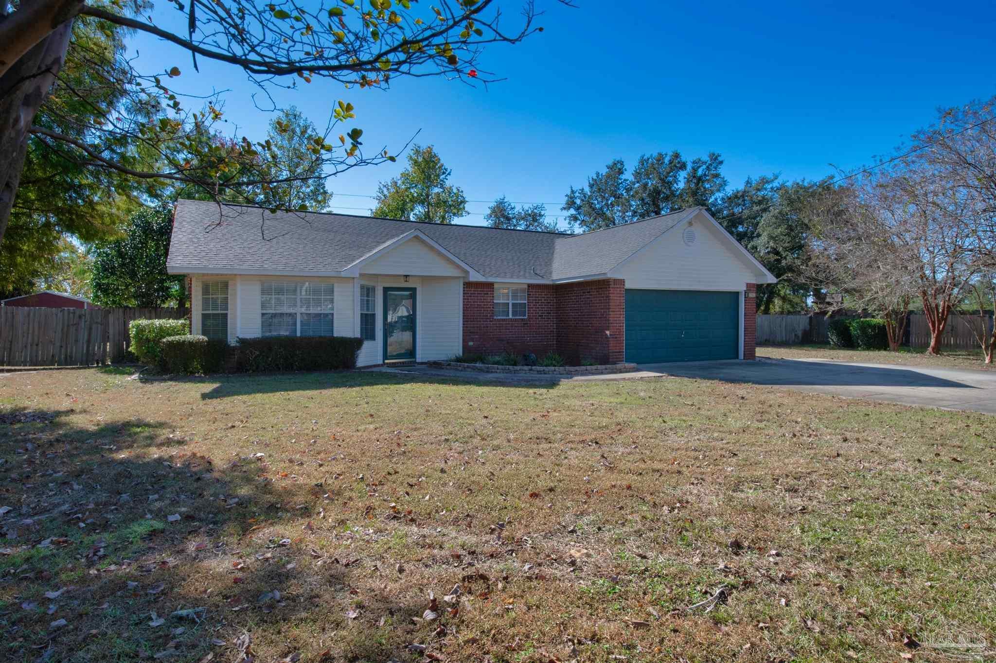 2702 Beacon Court Navarre, FL 32566 - Photo 3 of 29 a house with trees in the background